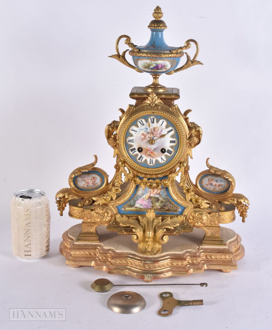 A 19TH CENTURY FRENCH GILT BRONZE SEVRES PORCELAIN CLOCK painted with figures and putti in landscape: A 19TH CENTURY FRENCH GILT BRONZE SEVRES PORCELAIN CLOCK painted with figures and putti in landscapes. Clock 38 cm x 30 cm.