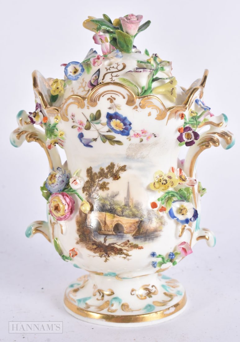 A MID 19TH CENTURY ENGLISH PORCELAIN ENCRUSTED POT POURRI AND COVER painted with landscapes and rive: A MID 19TH CENTURY ENGLISH PORCELAIN ENCRUSTED POT POURRI AND COVER painted with landscapes and rivers. 15 cm high.