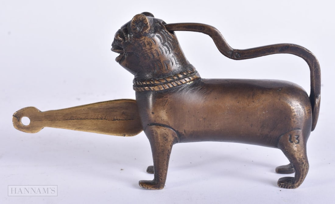 A 19TH CENTURY INDO PERSIAN BRONZE LION LOCK modelled standing upon all fours. 14 cm wide.: A 19TH CENTURY INDO PERSIAN BRONZE LION LOCK modelled standing upon all fours. 14 cm wide.