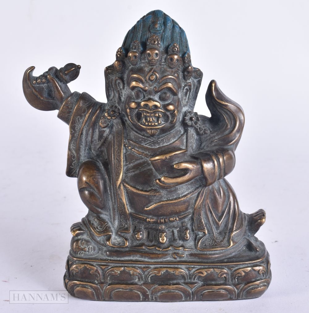 A TIBETAN BRONZE FIGURE OF A BUDDHIST DEITY modelled upon a lotus capped base. 12.5 cm x 9.5 cm. (1 of 4)