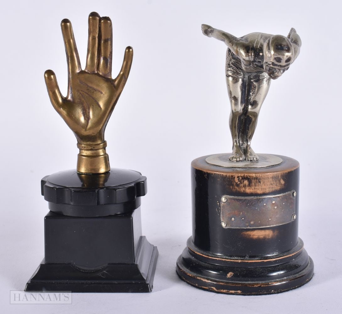A FLYING NYMPH CAR MASCOT together with an unusual palm car mascot. 14 cm high. (2) (1 of 5)