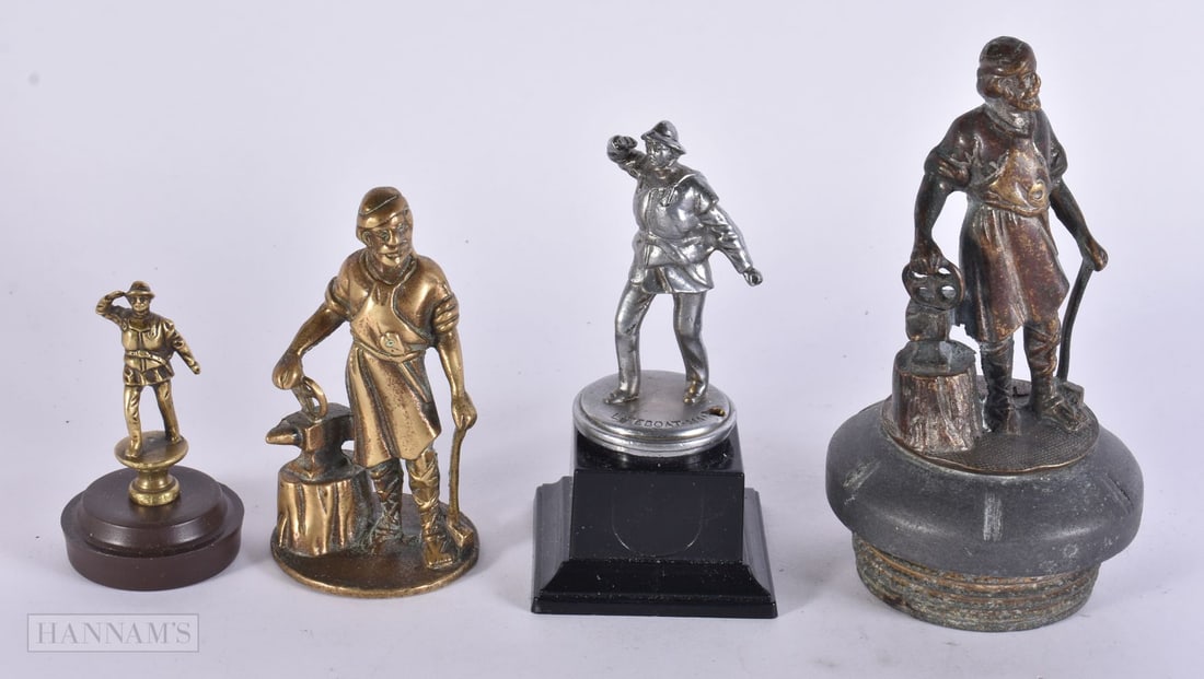 FOUR FIGURAL CAR MASCOTS including the blacksmith. Largest 17 cm high. (4) (1 of 5)