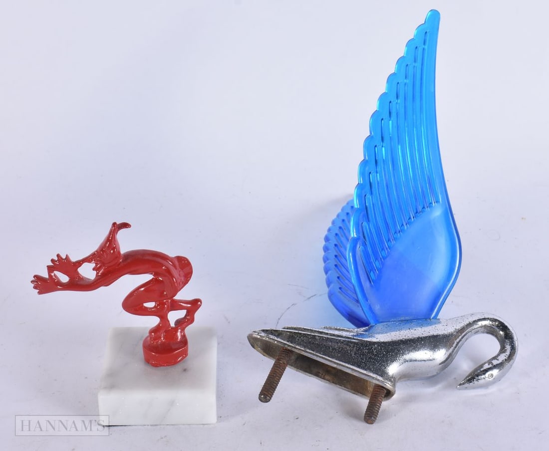 AN UNUSUAL BLUE WINGED BIRD CAR MASCOT together with a painted pixie mascot. Largest 18 cm x 12 cm. (1 of 3)
