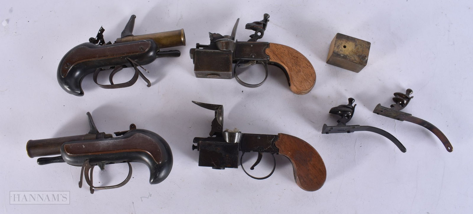 A COLLECTION OF ANTIQUE PISTOL LIGHTER PARTS AND SPARES. (qty): A COLLECTION OF ANTIQUE PISTOL LIGHTER PARTS AND SPARES. (qty)