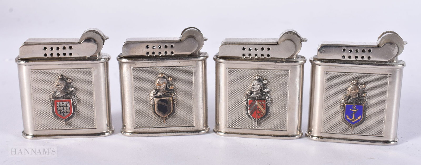 FOUR FRENCH PARIS ENAMELLED ARMORIAL DRAGO LIGHTERS. (4): FOUR FRENCH PARIS ENAMELLED ARMORIAL DRAGO LIGHTERS. (4)