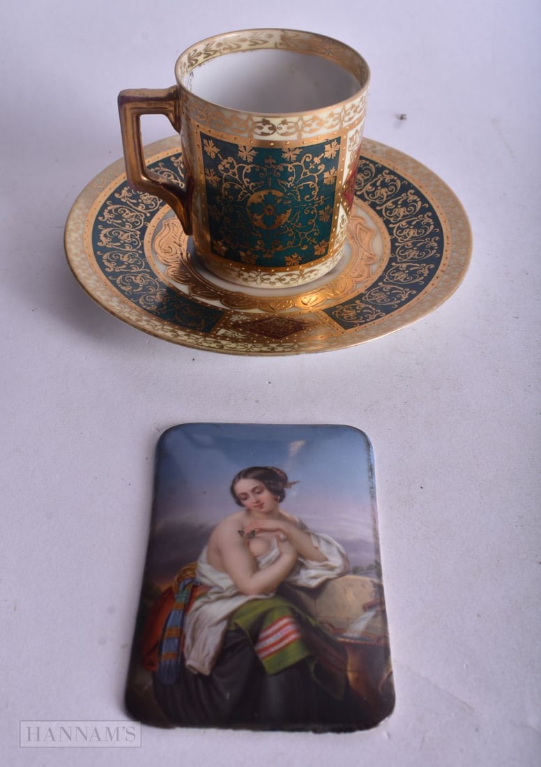 19th century German porcelain plaque painted with a mother and baby and an early 20th century ?Vienn: 19th century German porcelain plaque painted with a mother and baby and an early 20th century ?Vienna? cup and saucer painted with two lovers in a forest, largest 15 cm (3)