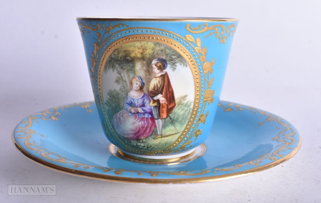 Coalport coffee cup and saucer painted with a courting couple in a forest, impressed and feint CBD m: Coalport coffee cup and saucer painted with a courting couple in a forest, impressed and feint CBD mark, 14 cm diameter
