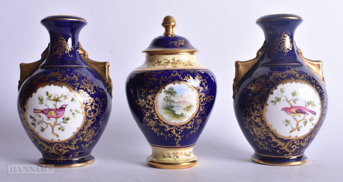 Coalport vase and cover painted with a view of Loch Tay on a gilt and blue ground, the landscape pai: Coalport vase and cover painted with a view of Loch Tay on a gilt and blue ground, the landscape painted by Percy Simpson, signed P.H.S., together with a pair of Coalport two handled vases painted wit