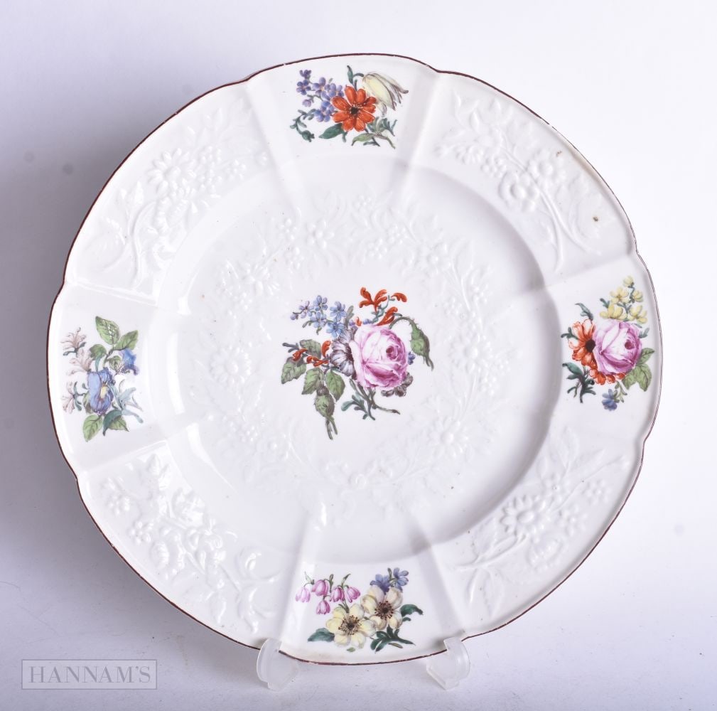 Chelsea Gotzkowsky moulded plate painted with four floral panels and a central bouquet, red anchor m: Chelsea Gotzkowsky moulded plate painted with four floral panels and a central bouquet, red anchor mark, 23 cm diameter