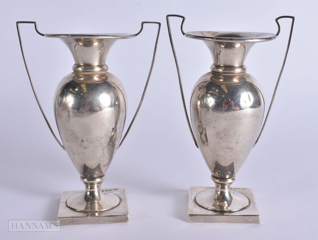 A PAIR OF SILVER TWIN HANDLED VASES. 135 grams. 15 cm high. (1 of 6)