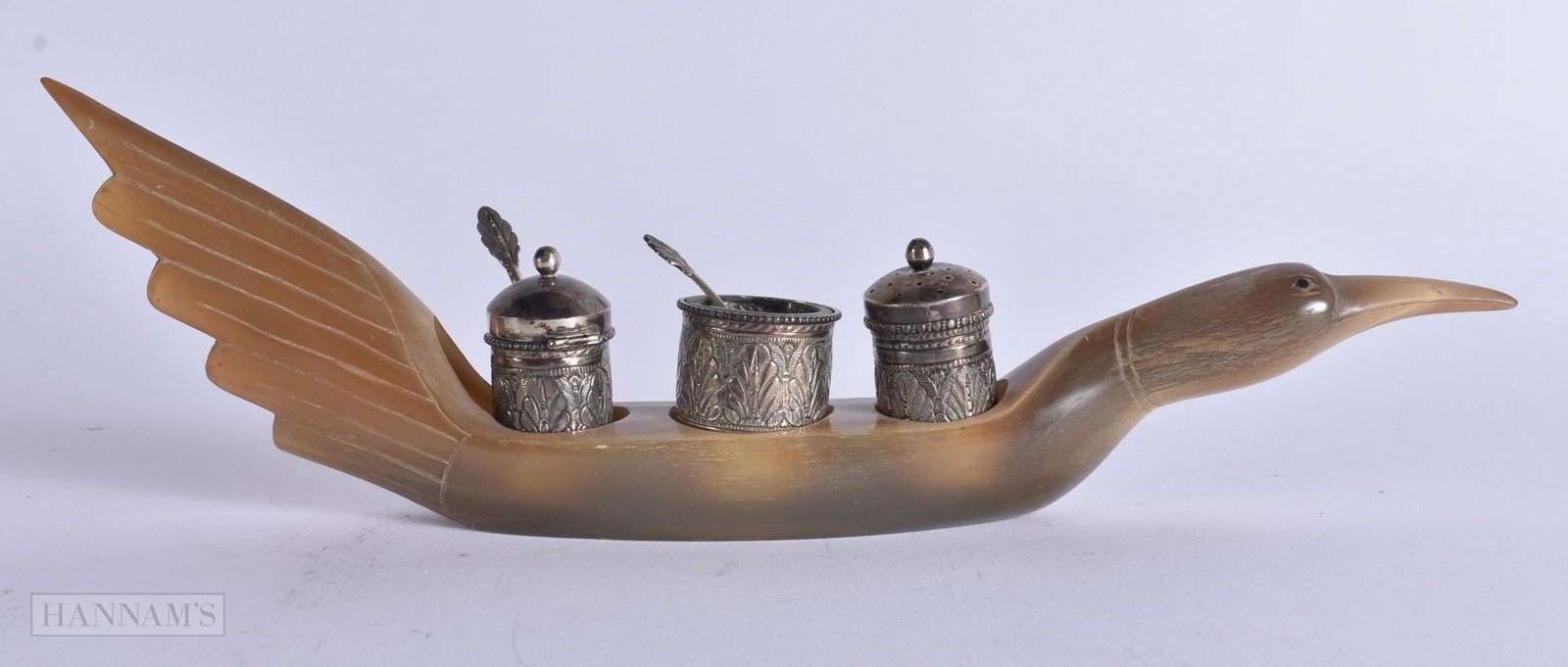 A LATE 19TH CENTURY ISLAMIC INDIAN CARVED HORN AND WHITE METAL CRUET SET. 261 grams. 27 cm wide.: A LATE 19TH CENTURY ISLAMIC INDIAN CARVED HORN AND WHITE METAL CRUET SET. 261 grams. 27 cm wide.