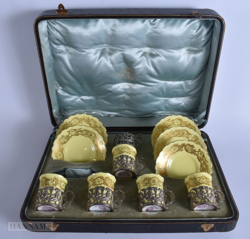 A CASED SET OF SILVER MOUNTED ROYAL WORCESTER CUPS AND SAUCERS. Silver 150 grams. (qty): A CASED SET OF SILVER MOUNTED ROYAL WORCESTER CUPS AND SAUCERS. Silver 150 grams. (qty)