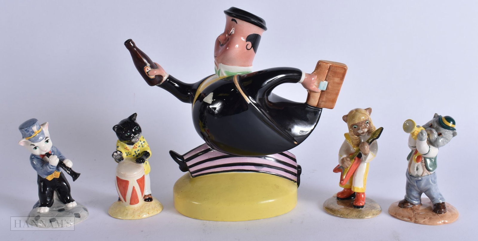 A BESWICK ADVERTISING FIGURE together with four Beswick animal musicians. Largest 20 cm x 18 cm. (5) (1 of 6)