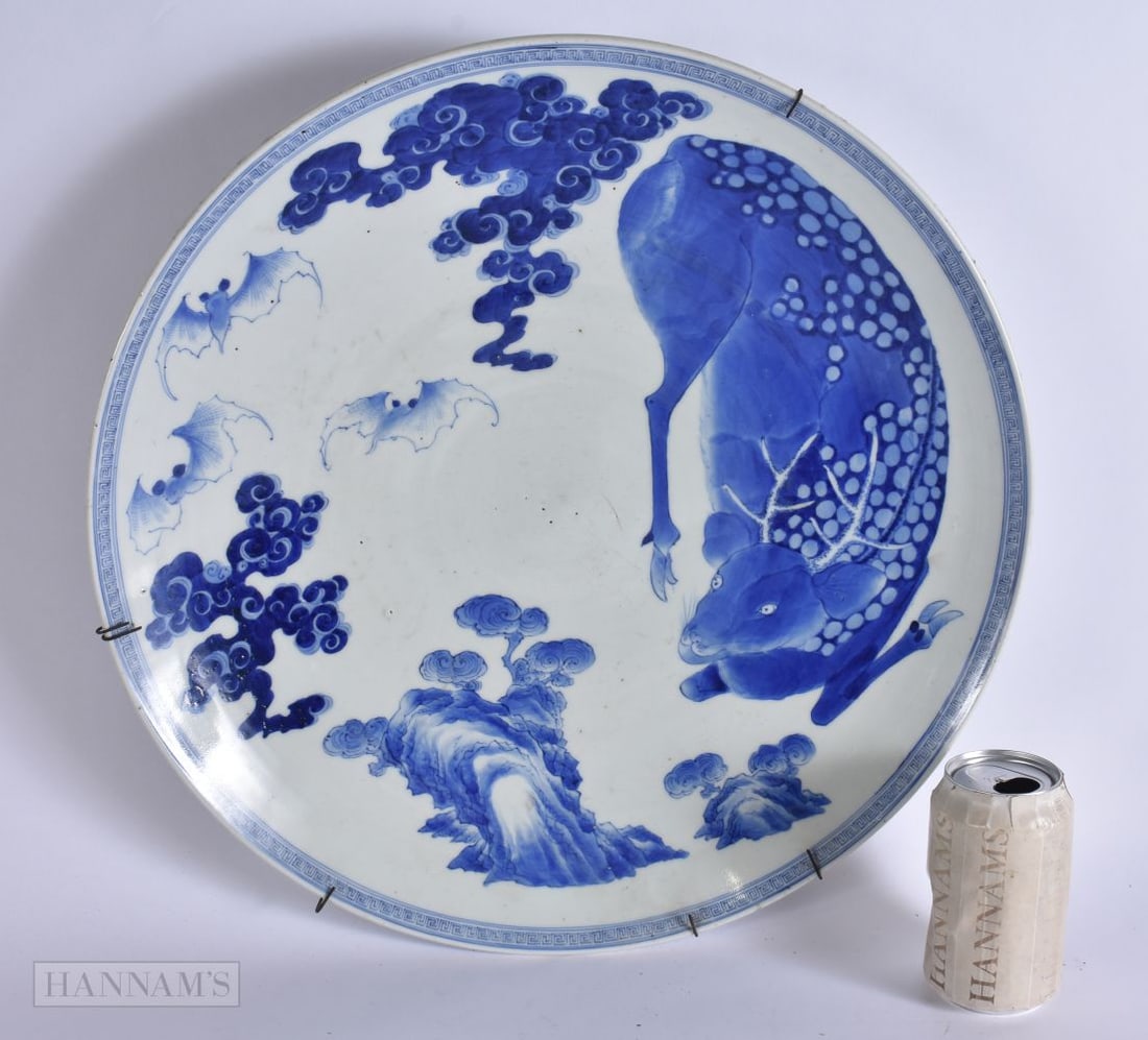 A LARGE 19TH CENTURY JAPANESE MEIJI PERIOD BLUE AND WHITE PORCELAIN DISH painted with a deer under c: A LARGE 19TH CENTURY JAPANESE MEIJI PERIOD BLUE AND WHITE PORCELAIN DISH painted with a deer under clouds and bats. 44 cm wide.