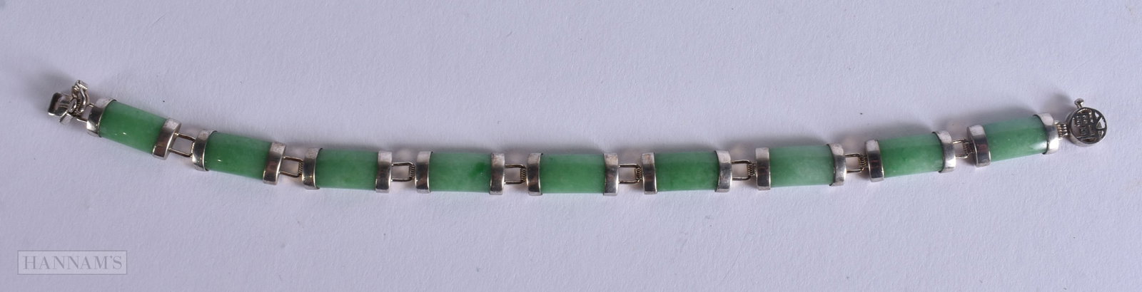 A CHINESE REPUBLICAN PERIOD SILVER MOUNTED JADEITE BRACELET. 18 cm wide. (1 of 5)