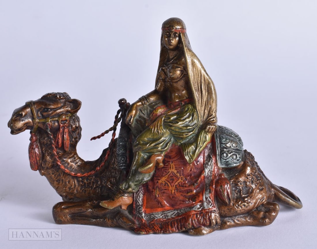 AN ANTIQUE COLD PAINTED BRONZE ARABIC CAMEL GROUP. 13 cm x 9.5 cm.: AN ANTIQUE COLD PAINTED BRONZE ARABIC CAMEL GROUP. 13 cm x 9.5 cm.