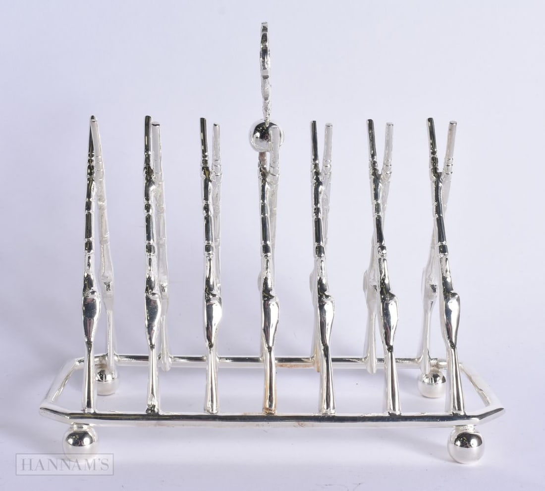 A SILVER PLATED RIFLE TOAST RACK. 20 cm x 18 cm. (1 of 5)