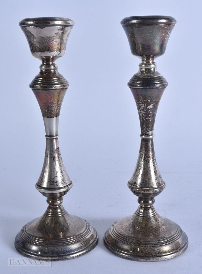 A PAIR OF SILVER CANDLESTICKS. 520 grams overall. 21 cm high. (1 of 5)
