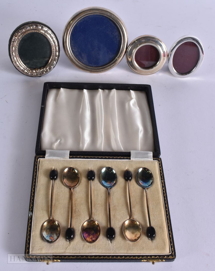 A SET OF SILVER COFFEE SPOONS together with four silver photograph frames. (5) (1 of 6)