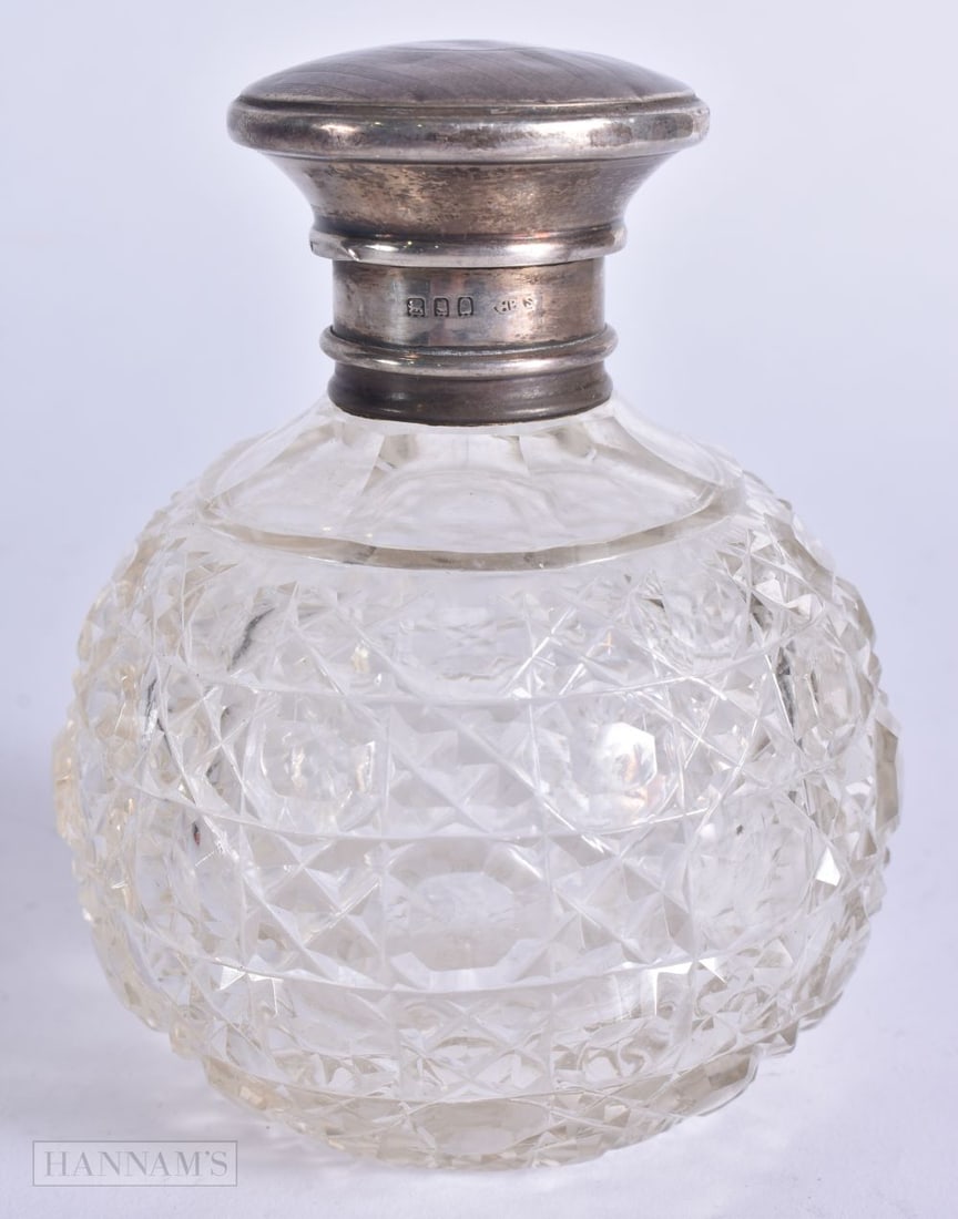 AN ANTIQUE SILVER MOUNTED CUT GLASS SCENT BOTTLE. 11 cm high. (1 of 4)