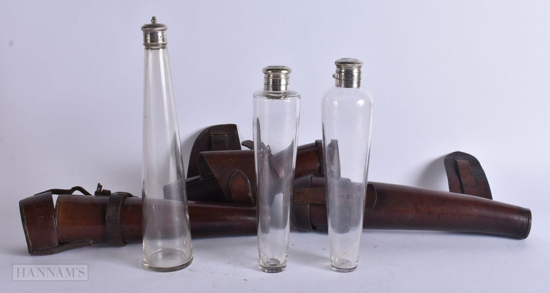 THREE ANTIQUE LEATHER CASED HIP FLASKS one mounted in silver. 27 cm high. (3) (1 of 4)