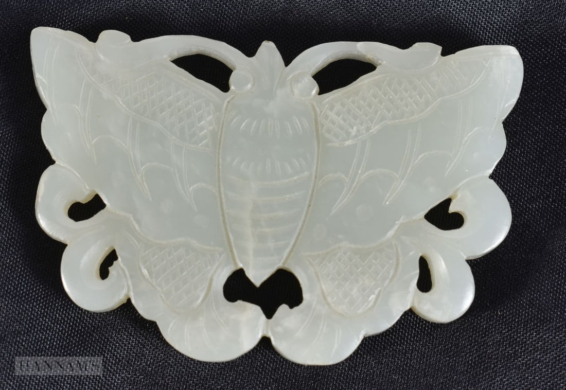 A CHINESE QING DYNASTY CARVED JADE PLAQUE formed as a moth. 6 cm x 4.5 cm.: A CHINESE QING DYNASTY CARVED JADE PLAQUE formed as a moth. 6 cm x 4.5 cm.