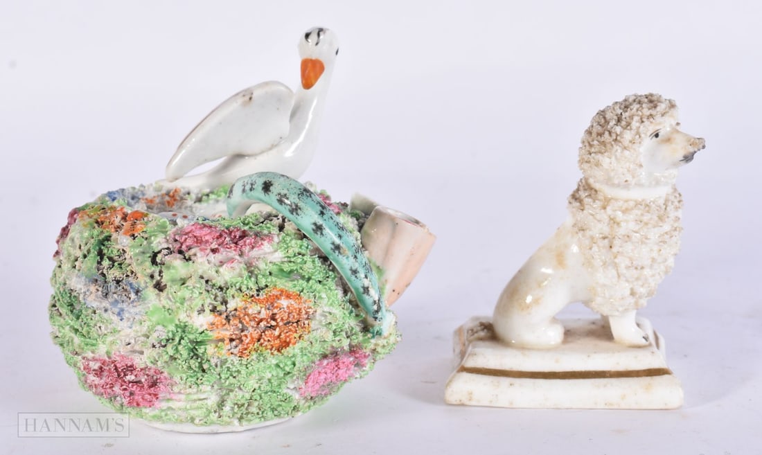A MID 19TH CENTURY STAFFORDSHIRE BIRD, EGG AND SERPENT INKWELL together with a Staffordshire poodle.: A MID 19TH CENTURY STAFFORDSHIRE BIRD, EGG AND SERPENT INKWELL together with a Staffordshire poodle. Largest 11 cm x 8 cm. (2)