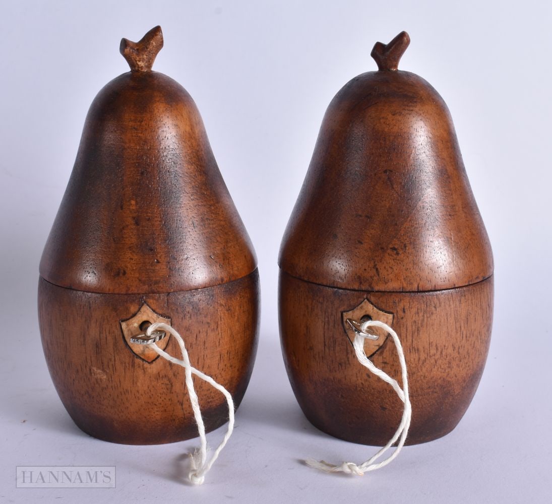 A PAIR OF TREEN CARVED WOOD FRUIT TEA CADDIES. 18 cm high. (1 of 4)