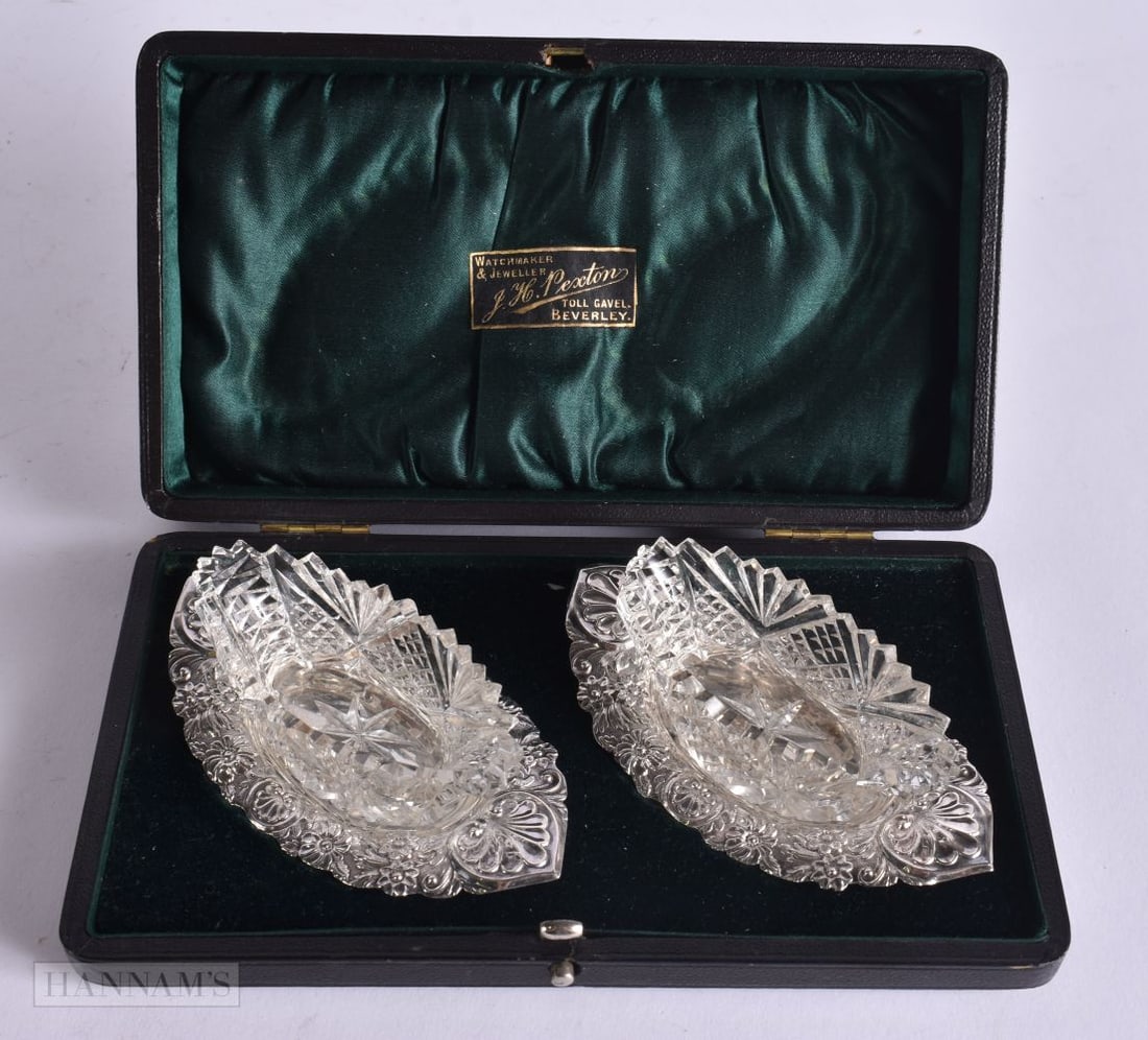 A PAIR OF SILVER AND CRYSTAL GLASS SALTS. Silver 42 grams. Each salt 9.5 cm wide. (1 of 5)