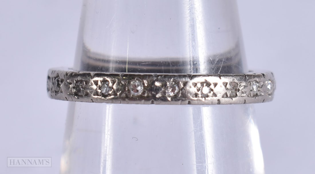 AN 18CT GOLD ETERNITY RING. L. 3.5 grams. (1 of 3)