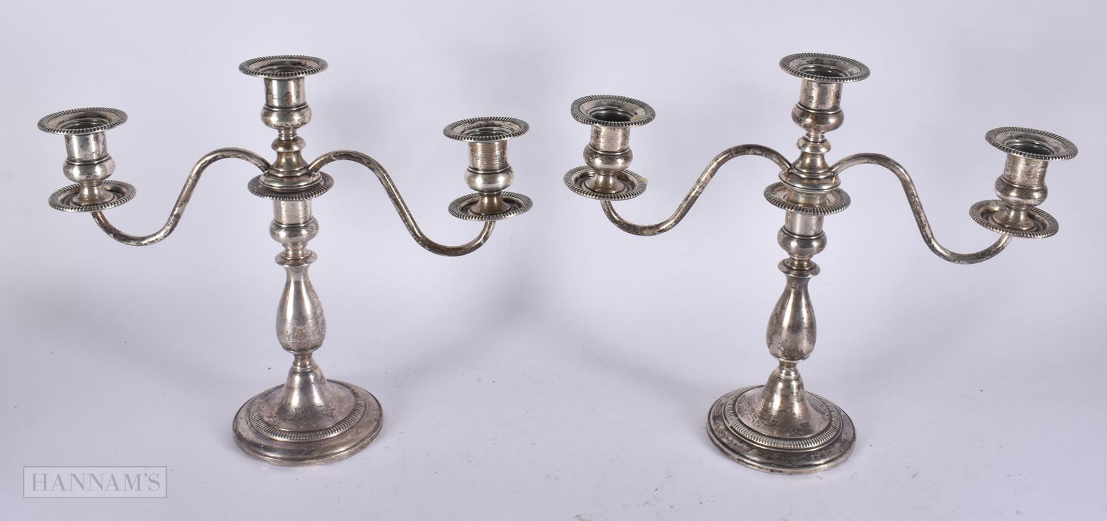 A PAIR OF SILVER CANDELABRA. 1280 grams overall. 35 cm x 25 cm. (1 of 3)