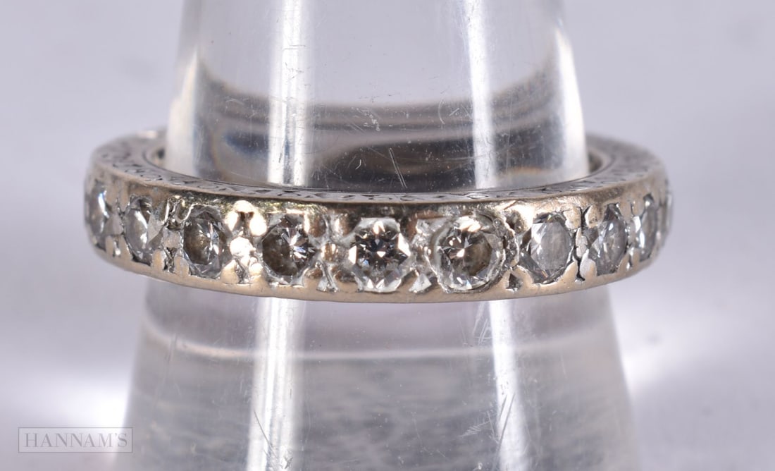 AN 18CT GOLD AND DIAMOND ETERNITY RING. 8.9 grams. T. (1 of 2)