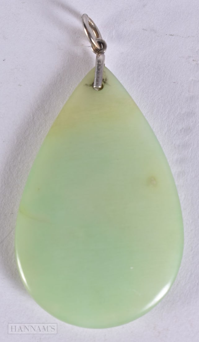 A JADE GLASS PENDANT. 6.75 cm x 3.5 cm. (1 of 2)