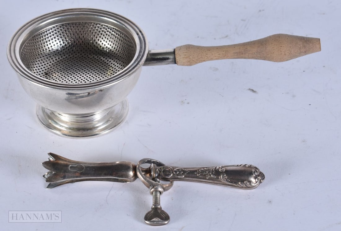 A SILVER TEA STRAINER ON STAND and a posy holder. Weighable silver 38 grams. (3) (1 of 3)