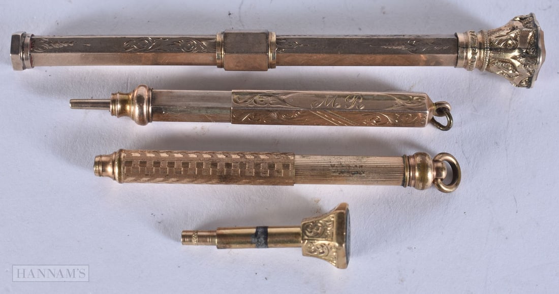 THREE ANTIQUE YELLOW METAL PROPELLING PENCILS together with a similar seal. 35 grams. (4) (1 of 2)