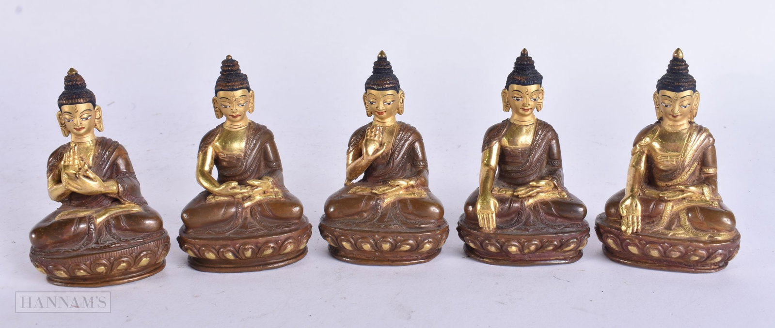 A SET OF FIVE TIBETAN BRONZE ENAMELLED BUDDHAS. 8.25 cm high. (5) (1 of 5)