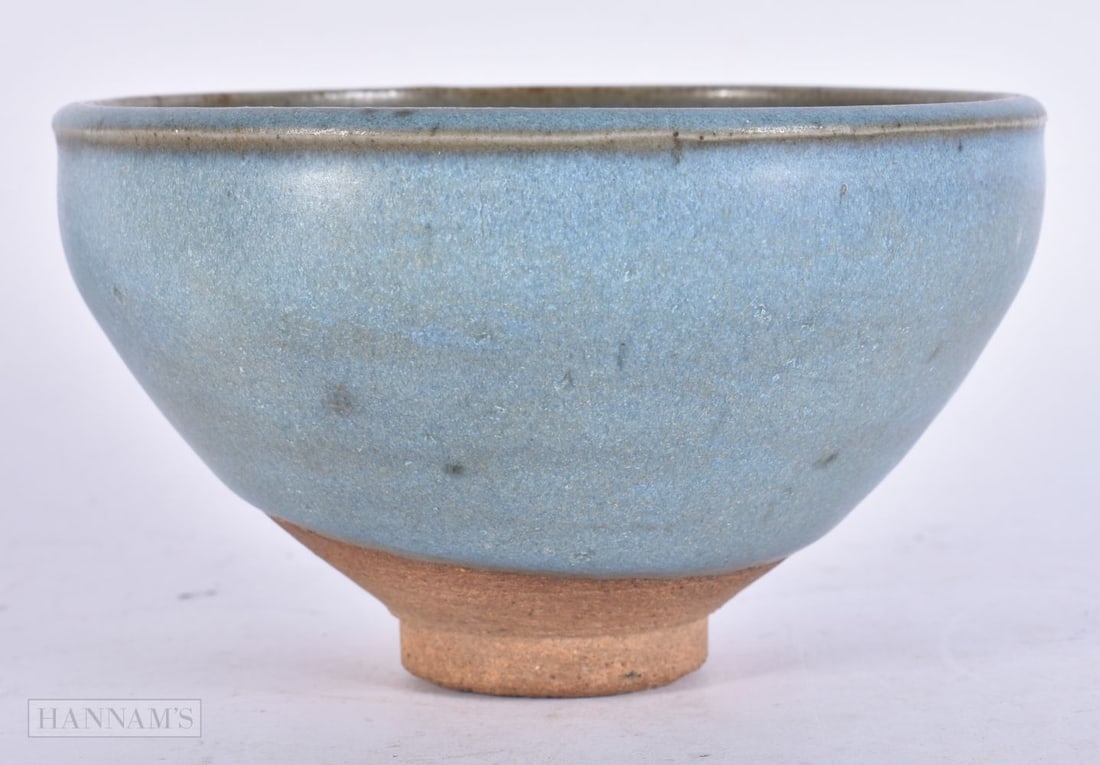 A CHINESE JUNYAO STONEWARE POTTERY BOWL Yuan (1271-1368), with aubergine glazed lip and purple splas: A CHINESE JUNYAO STONEWARE POTTERY BOWL Yuan (1271-1368), with aubergine glazed lip and purple splash decoration to body. 12 cm wide.