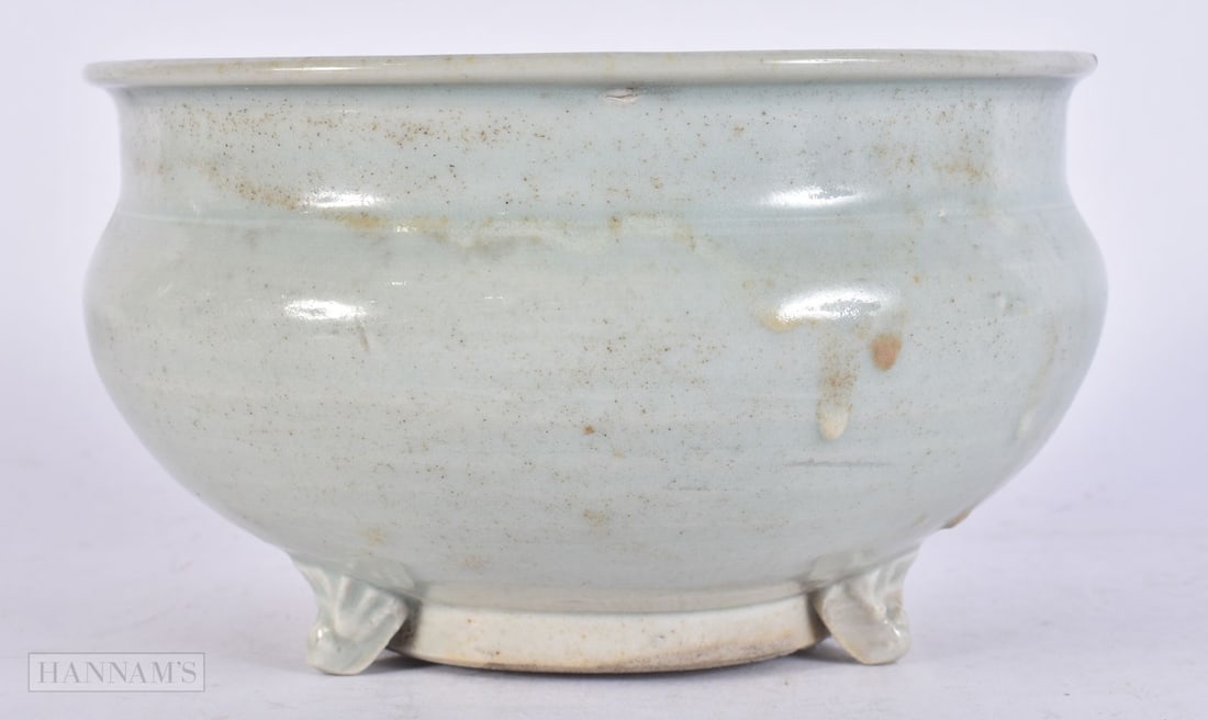 A CHINESE PALE BLUE GLAZED CENSER Early Ming, supported upon three slender mask head feet. 15 cm wid (1 of 5)