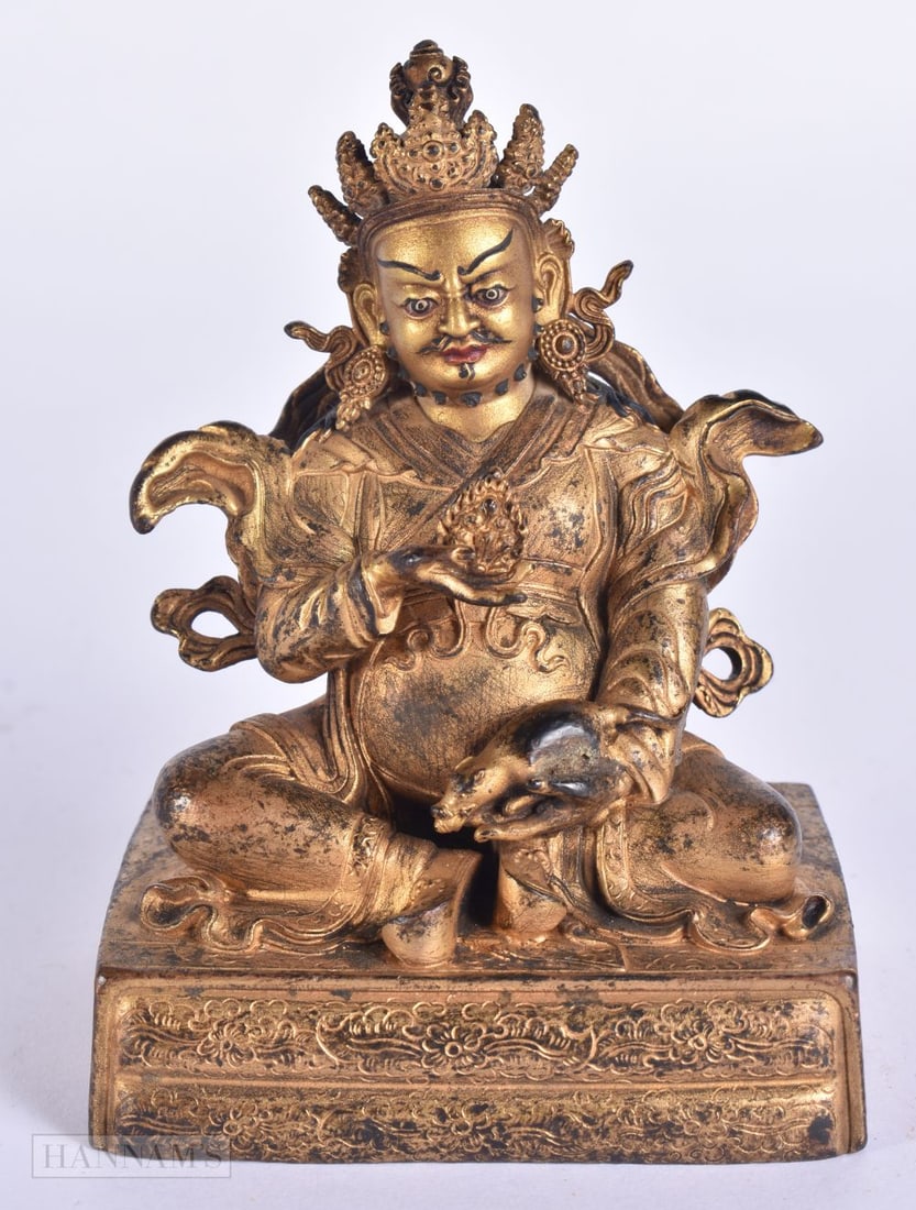 A TIBETAN BRONZE FIGURE OF A SEATED BUDDHA modelled upon a base incised with foliage. 11 cm x 6 cm.: A TIBETAN BRONZE FIGURE OF A SEATED BUDDHA modelled upon a base incised with foliage. 11 cm x 6 cm.