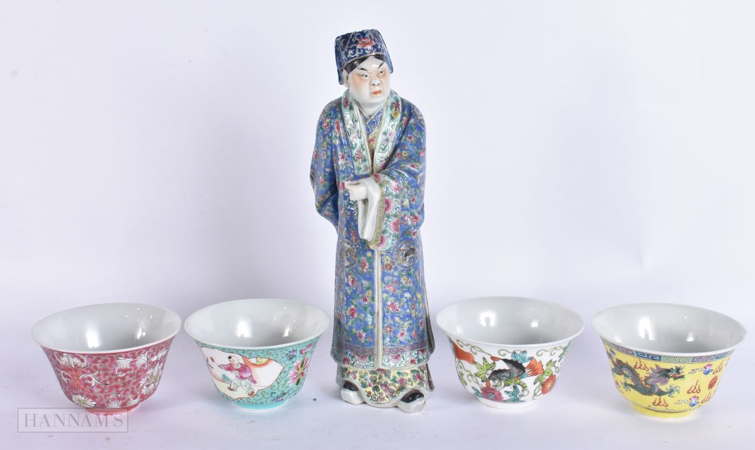 AN EARLY 20TH CENTURY CHINESE PORCELAIN FIGURE OF A MALE Late Qing/Republic, together with four teab: AN EARLY 20TH CENTURY CHINESE PORCELAIN FIGURE OF A MALE Late Qing/Republic, together with four teabowls. Largest 28 cm high. (5)
