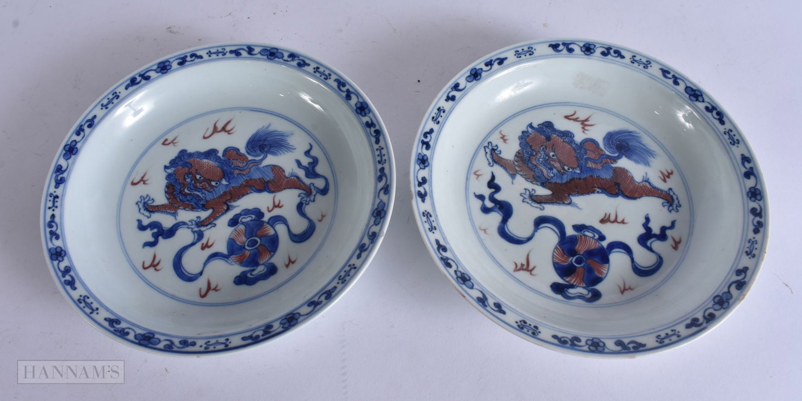 A PAIR OF CHINESE QING DYNASTY BLUE AND WHITE IRON RED PORCELAIN DISHES Qianlong mark and probably l: A PAIR OF CHINESE QING DYNASTY BLUE AND WHITE IRON RED PORCELAIN DISHES Qianlong mark and probably late in the period. 21.5 cm wide.