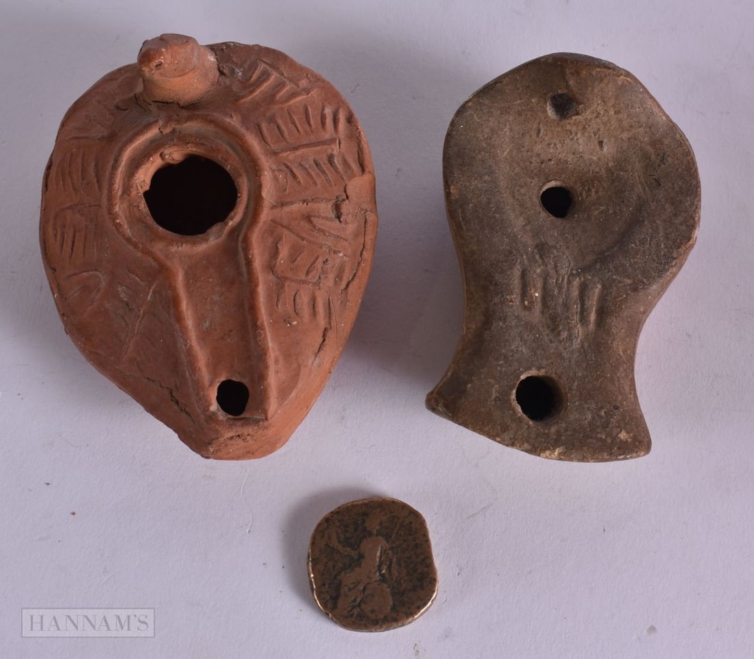TWO EARLY OIL LAMPS possibly antiquity and a coin. (3) (1 of 4)