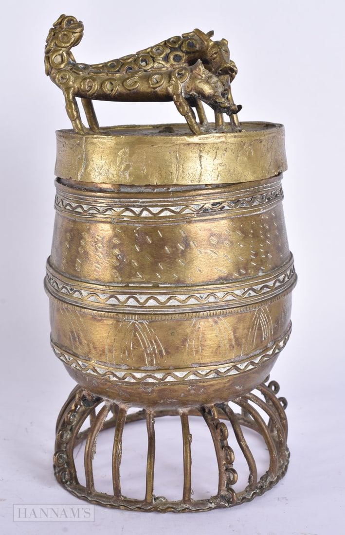 A 19TH CENTURY EASTERN BRONZE VESSEL AND COVER formed with two spotted beasts. 22 cm high. (1 of 4)