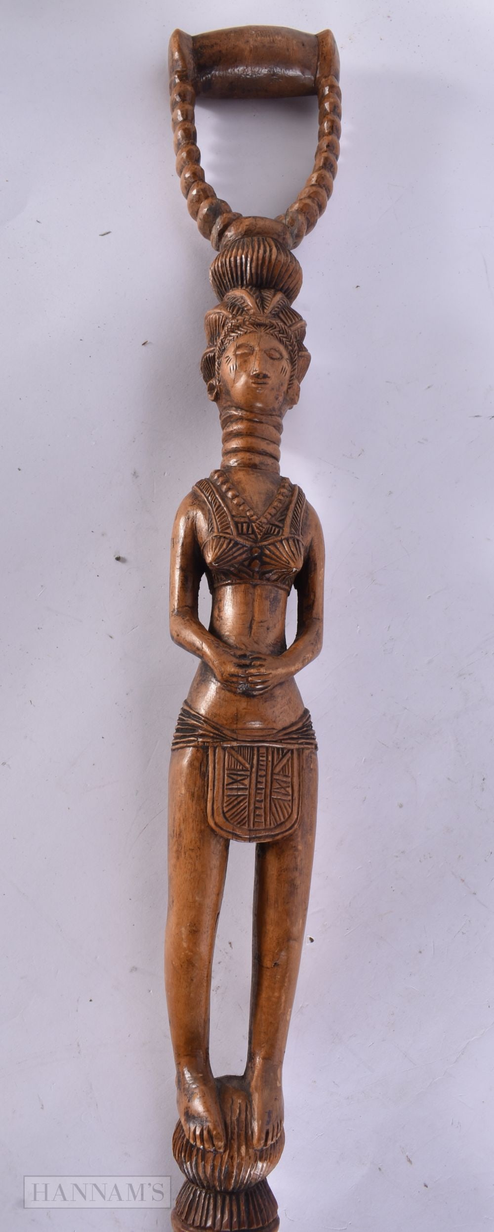 AN EARLY 20TH CENTURY AFRICAN CARVED WOOD FERTILITY STAFF formed with a female upon a stem carved wi: AN EARLY 20TH CENTURY AFRICAN CARVED WOOD FERTILITY STAFF formed with a female upon a stem carved with animals. 90 cm long.