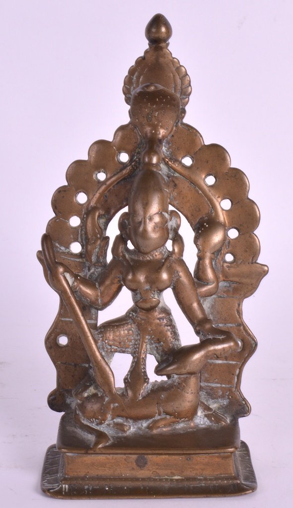 A 16TH CENTURY INDIAN BRONZE FIGURE OF SHIVA modelled: A 16TH CENTURY INDIAN BRONZE FIGURE OF SHIVA modelled standing in front of pierced arch, upon a rectangular base. 6ins high.
