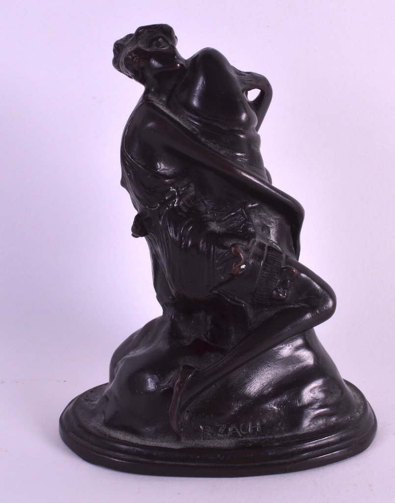 AFTER BRUNO ZACH (1891-1935) GERMAN AN UNUSUAL BRONZE: AFTER BRUNO ZACH (1891-1935) GERMAN AN UNUSUAL BRONZE FIGURE OF A FEMALE modelled holding onto a phallic. Signed. 6.25ins high. £30-50