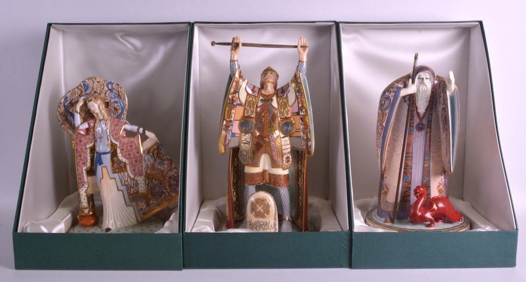 A SET OF THREE BOXED MINTON ARTHURIAN LEGENDS each: A SET OF THREE BOXED MINTON ARTHURIAN LEGENDS each modelled with silver swords, painted in vibrant enamels. Largest 1ft 4.5ins high. (3) £800-1200