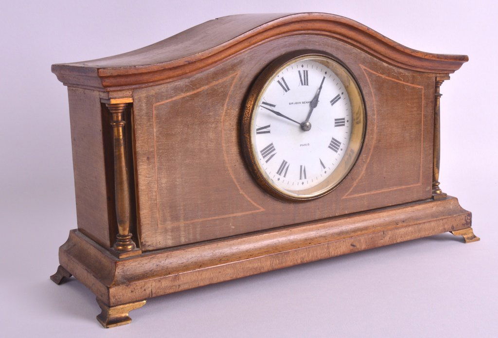 A LATE 19TH CENTURY MAHOGANY INLAID MANTEL CLOCK by Sir: A LATE 19TH CENTURY MAHOGANY INLAID MANTEL CLOCK by Sir John Bennett Ltd (1814-1897) with white enamel dial and brass fittings. 11.25ins wide.