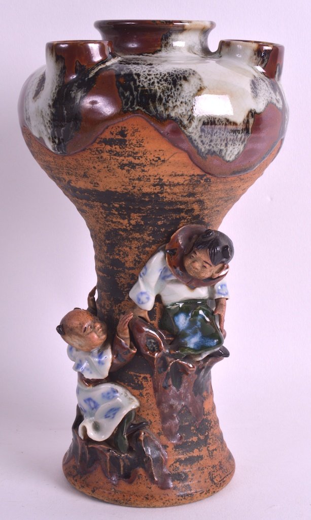 AN EARLY 20TH CENTURY JAPANESE SUMIDA GAWA WARE POSY: AN EARLY 20TH CENTURY JAPANESE SUMIDA GAWA WARE POSY VASE overlaid with two figures upon a rocky outcrop. Signed. 8.5ins high.
