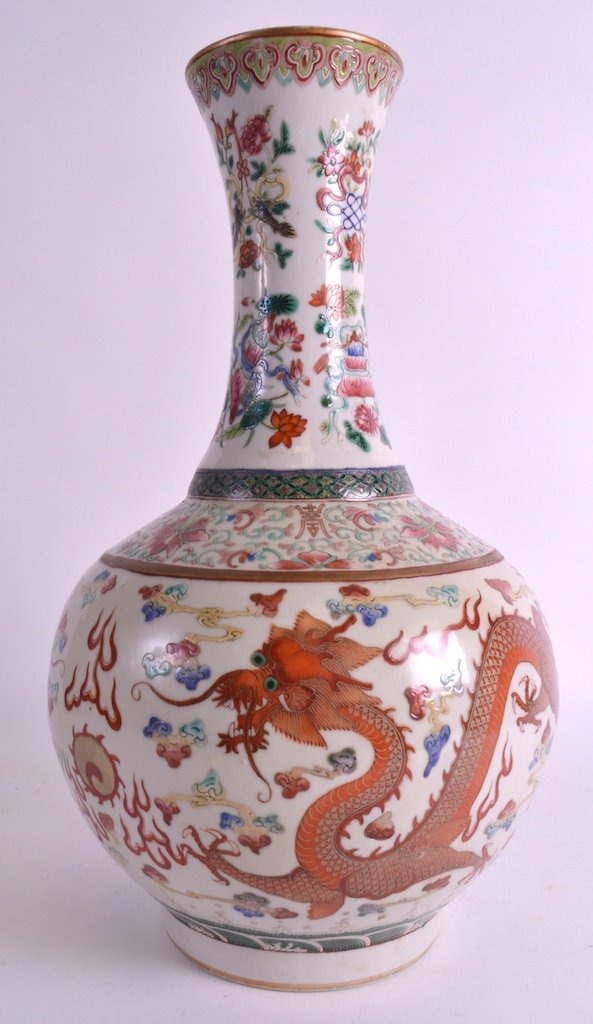 A LATE 19TH CENTURY CHINESE BULBOUS FAMILLE ROSE VASE: A LATE 19TH CENTURY CHINESE BULBOUS FAMILLE ROSE VASE Guangxu, bearing Qianlong marks to base, enamelled with dragons amongst crashing waves and motifs. 1ft 3ins high.